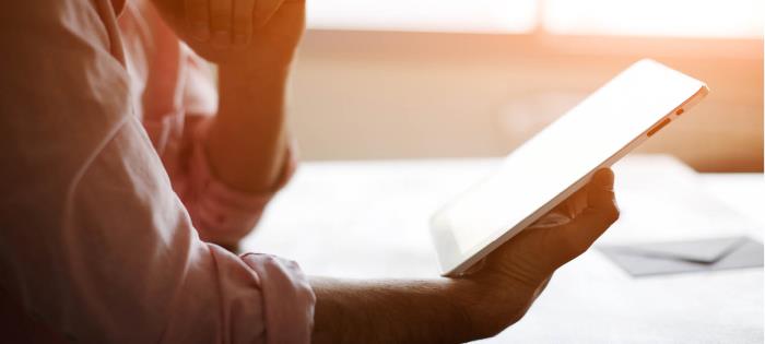 person reading communications on a tablet
